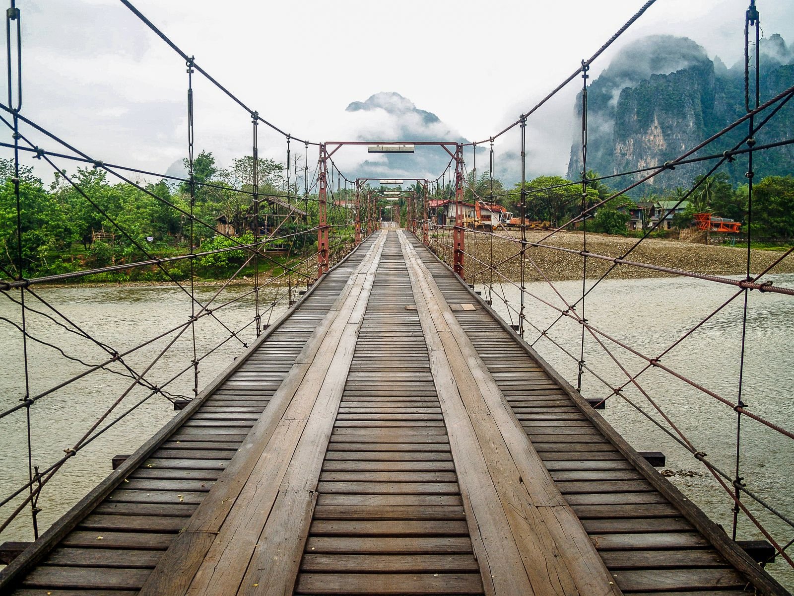Suspension bridge and misty mountains in Vang Vieng, Laos
