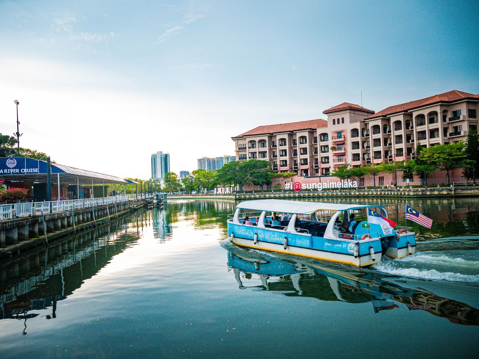 Boat and waterfront buildings on the Malacca River