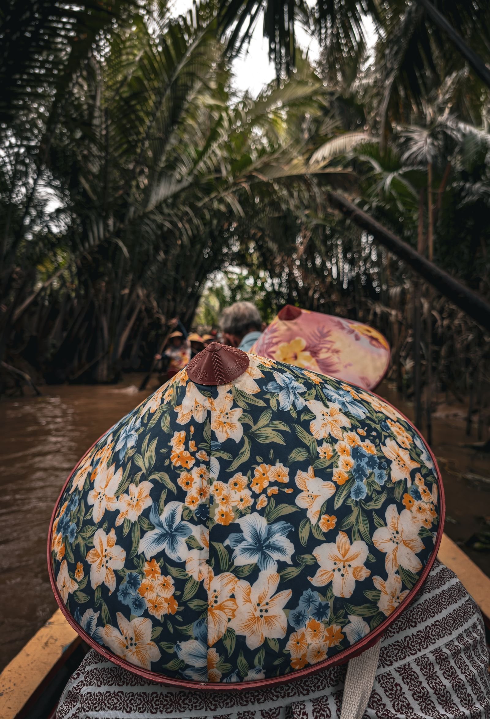 Traditional boat among tropical greenery in the Mekong Delta, Vietnam