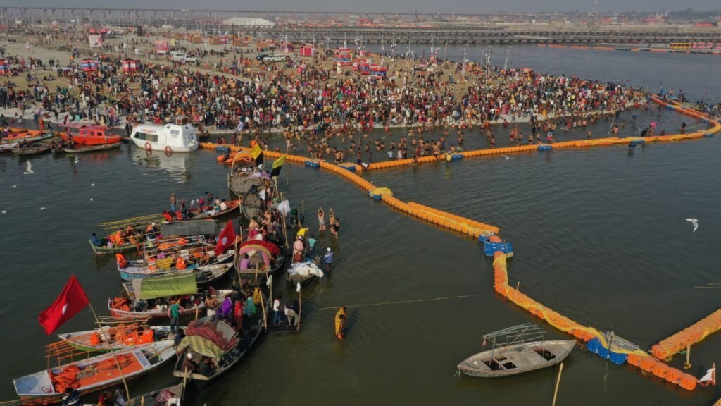 Crowds and boats gathering for a festival along an Indian river